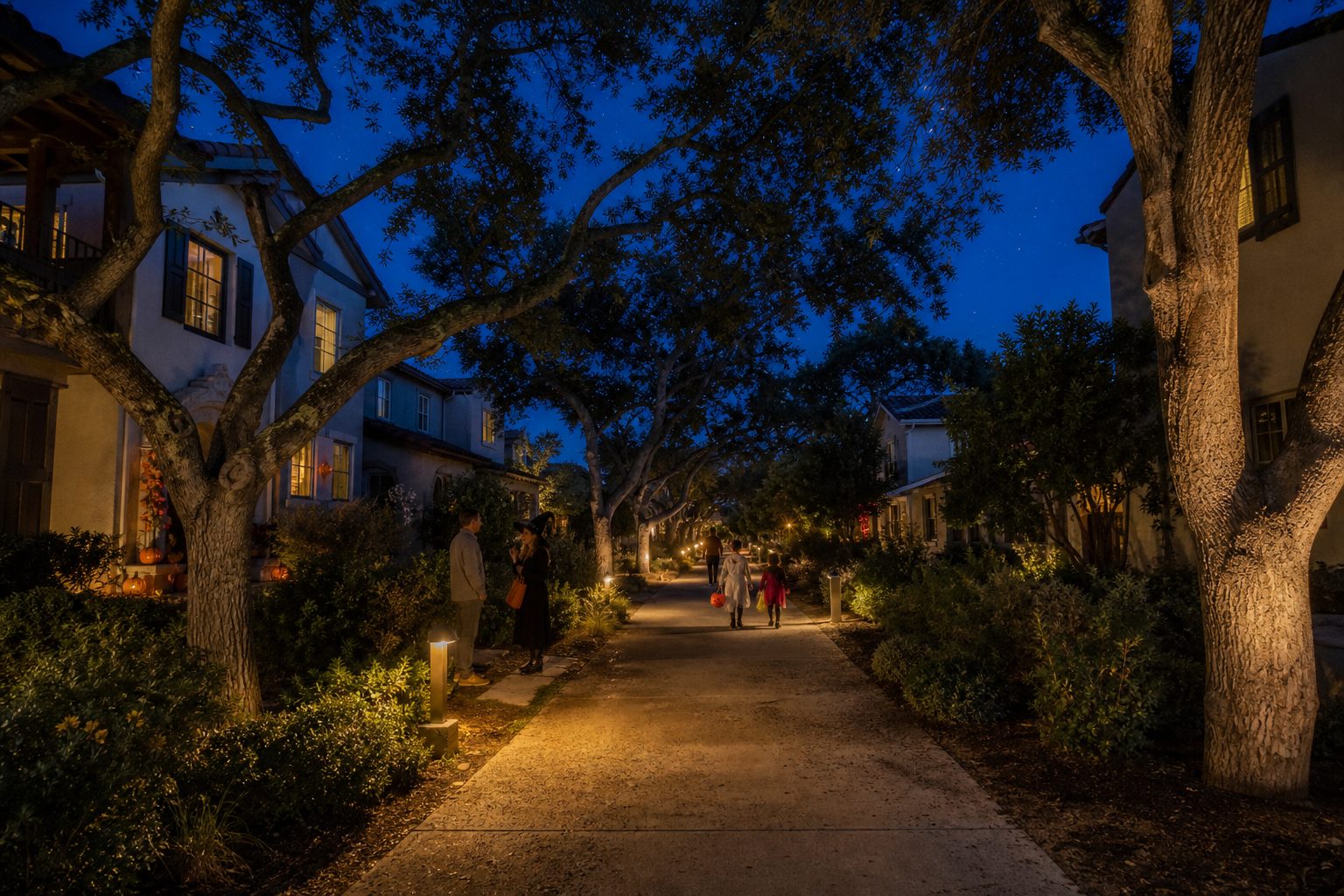 Neighbors and families walking the paseo trail system in Valencia's Old Orchard neighborhood during Halloween evening.