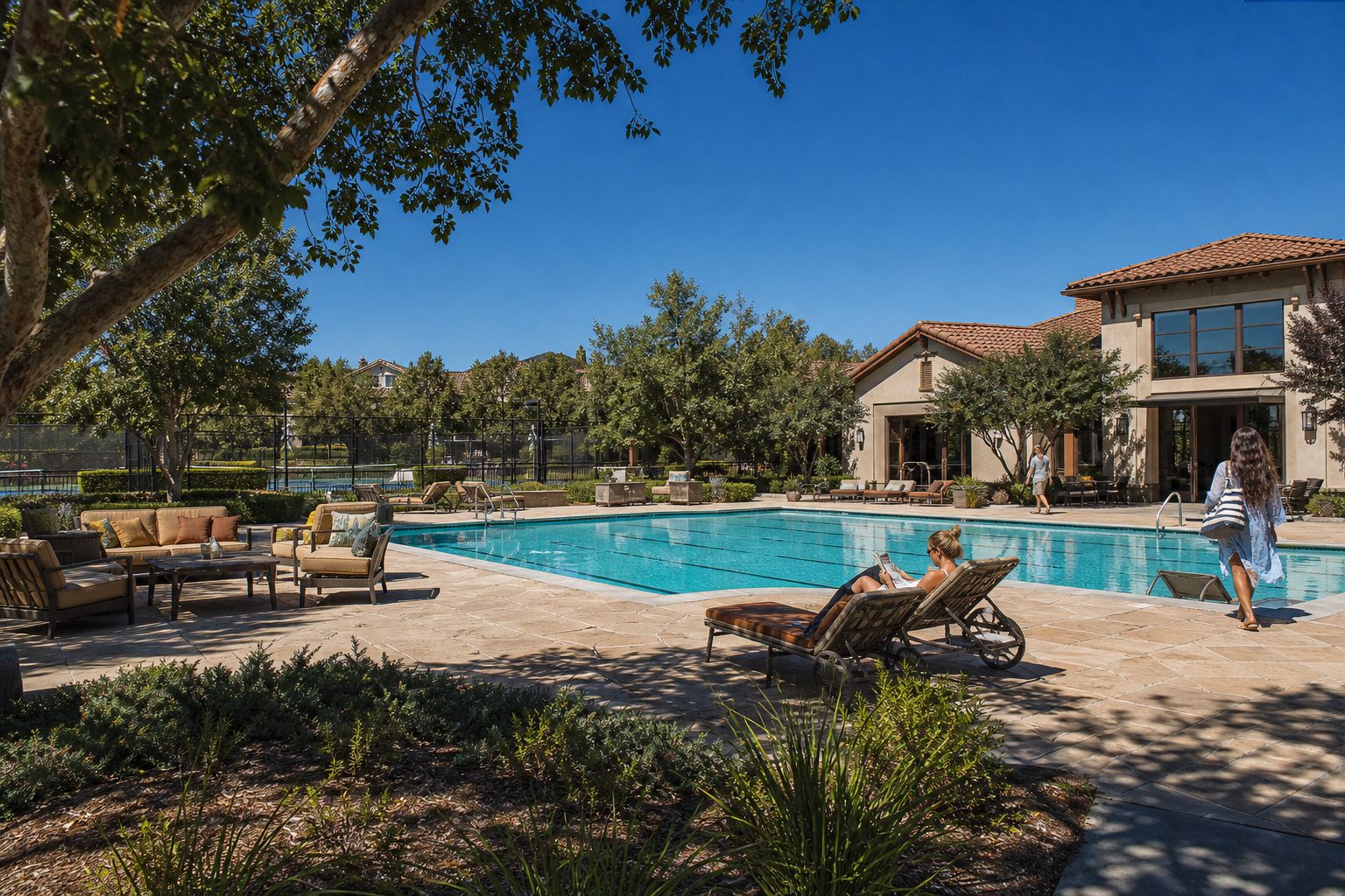 Resort-style pool and clubhouse amenities with mature trees and residents at Northpark Valencia community center.