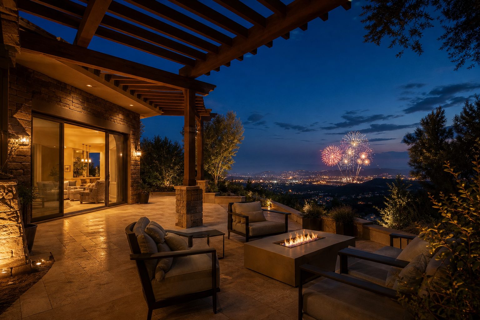 Empty luxury home patio on a hilltop at twilight with distant Fourth of July fireworks visible in the night sky over the Santa Clarita Valley.